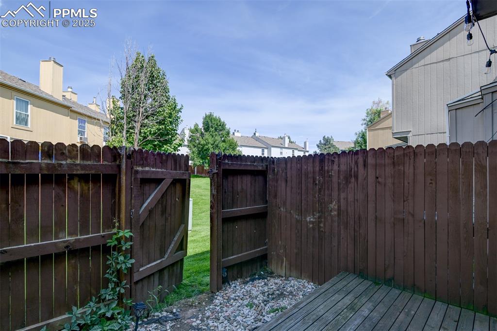 Private fenced patio opens to greenspace.