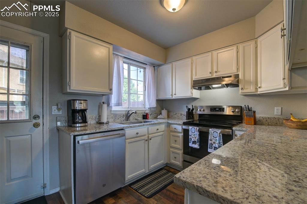 Nice white kitchen with granite countertops. Stainless sink and appliances. 