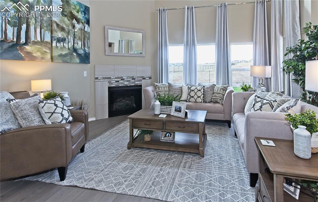 Living area with wood finished floors and a tiled fireplace