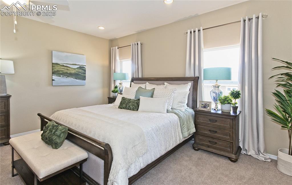 Bedroom featuring light colored carpet, recessed lighting, and a ceiling fan