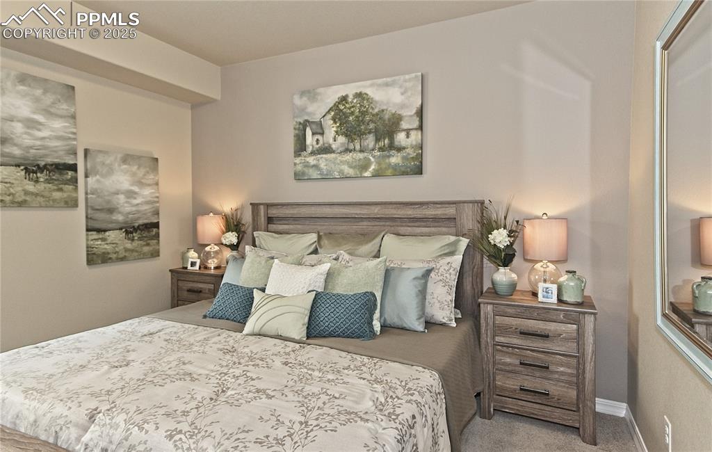 Bedroom featuring carpet floors and baseboards