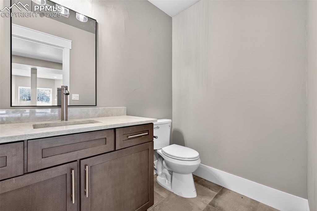 Lower-Level Half bath with vanity and toilet