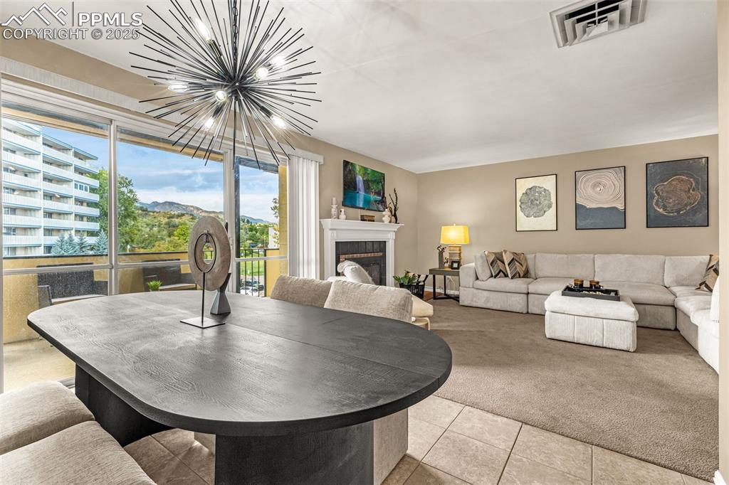 Light and bright dining area has mountain views through the walk-out sliding glass doors