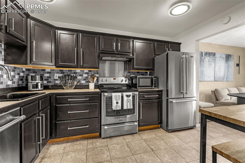 Updated kitchen with stainless steel appliances, attractive backsplash and updated hardware and lighting (battery operated)