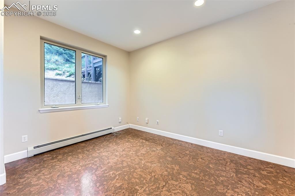 Office with cork floors, a baseboard radiator and recessed lighting