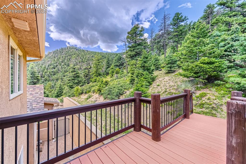 Wooden terrace featuring a view of trees