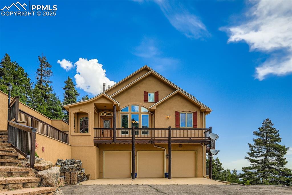 View of front of home featuring stucco siding, concrete driveway, and an attached 3-car garage