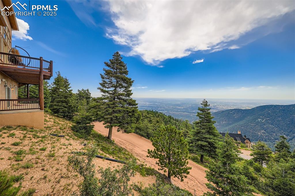View of yard featuring a balcony and a city and mountain view