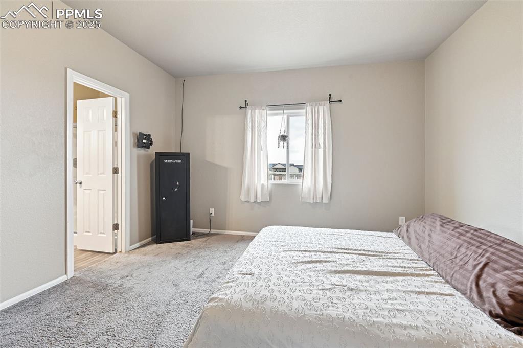Carpeted bedroom with baseboards
