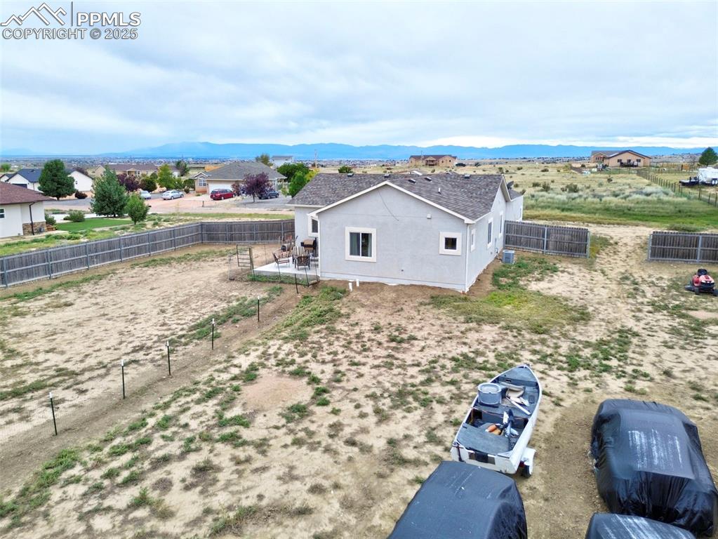 Aerial view of property and surrounding area with mountains