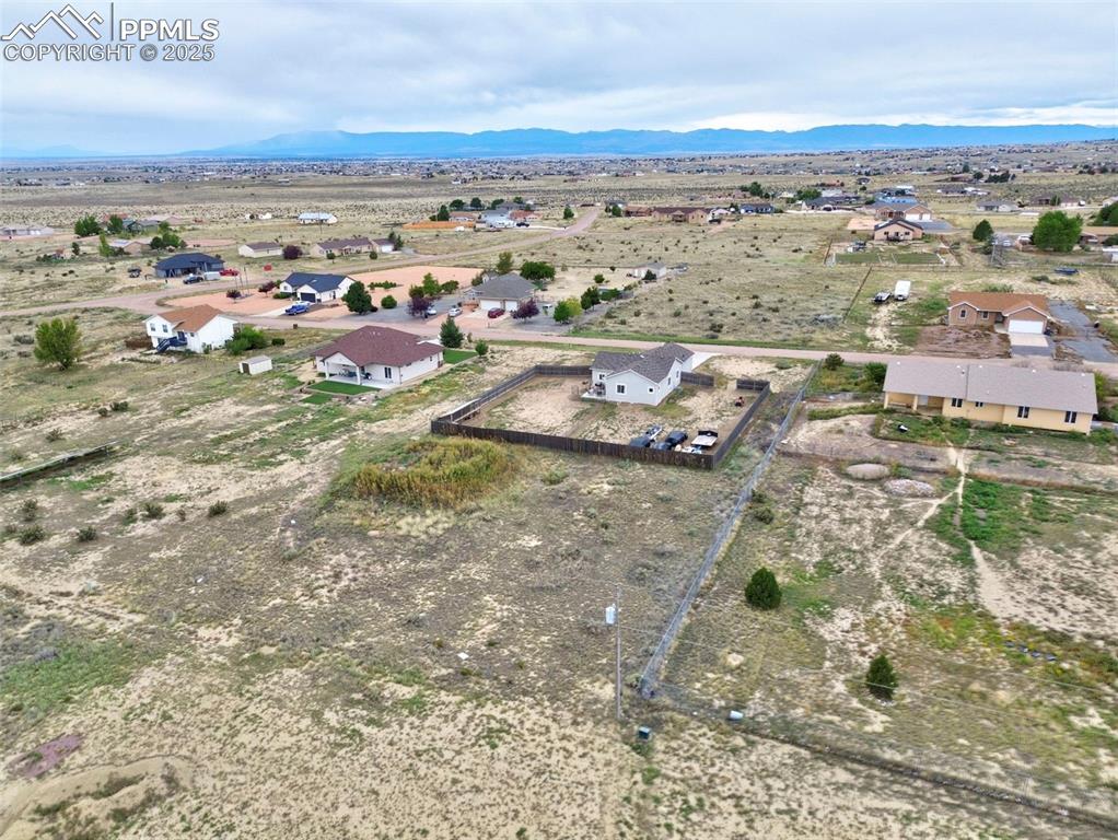 Overview of rural landscape featuring nearby suburban area and mountains