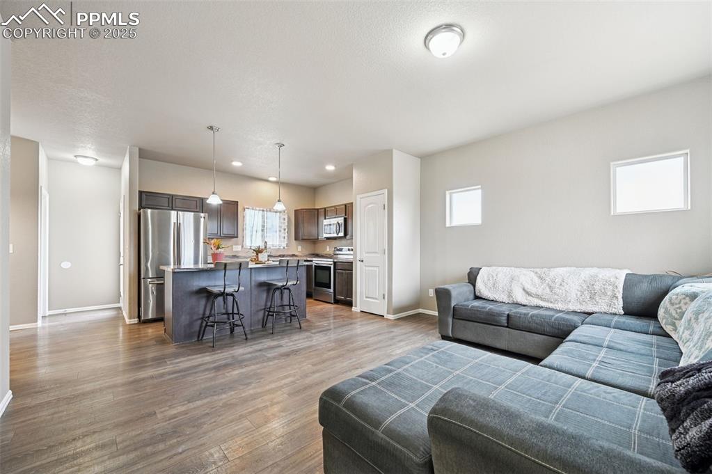Living room featuring dark wood-style flooring and recessed lighting
