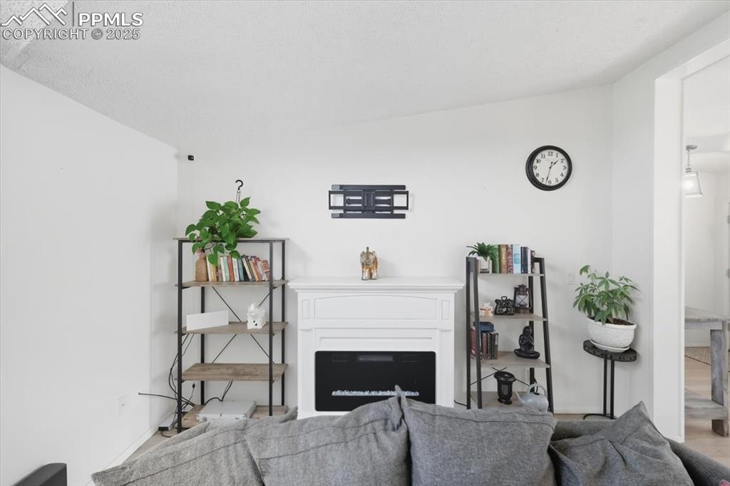Living area with a fireplace and wood finished floors
