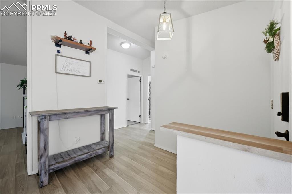 Hall featuring light wood-style floors