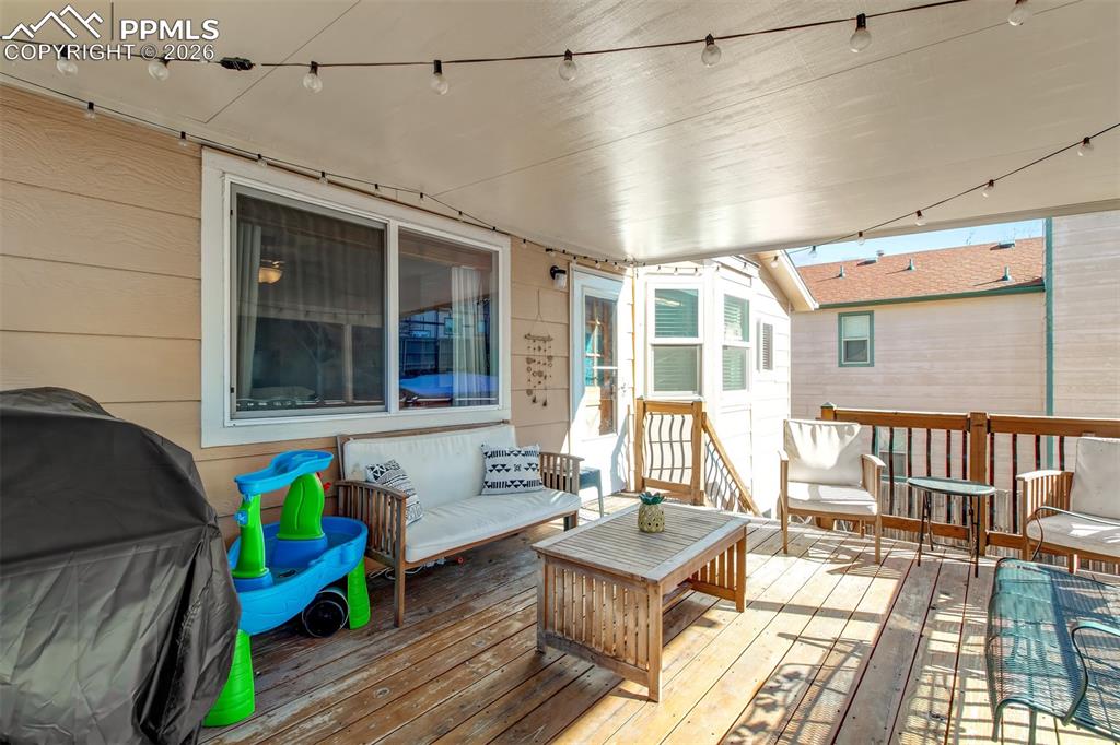 The wood deck offers a great amount of space for seating to enjoy the outdoor space with friends and family