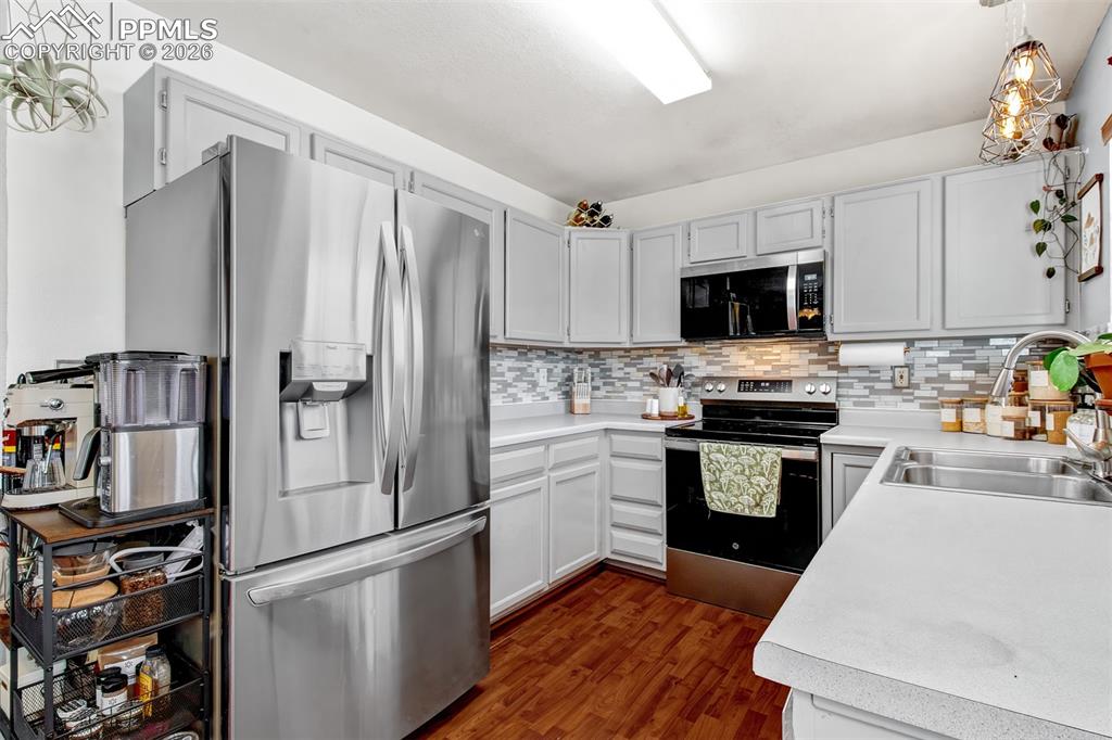 Beautiful bright kitchen with newer stainless appliances and full height backsplash