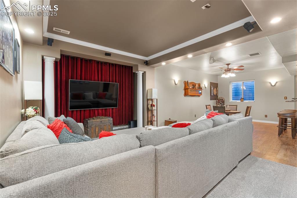 Living room with ornamental molding, recessed lighting, a ceiling fan, and light wood finished floors