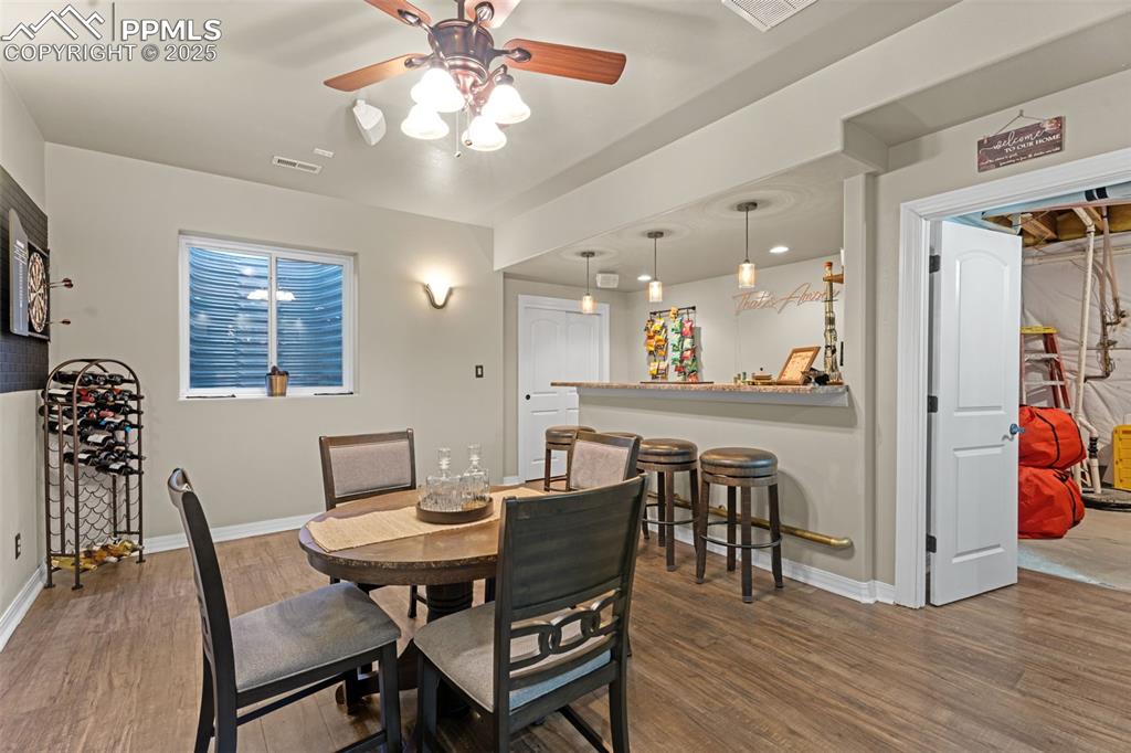 Dining room featuring wood finished floors and a ceiling fan