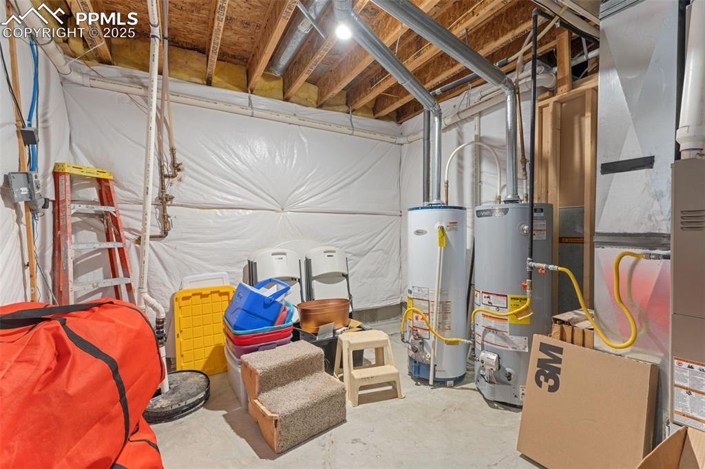 Unfinished basement with gas water heater and heating unit