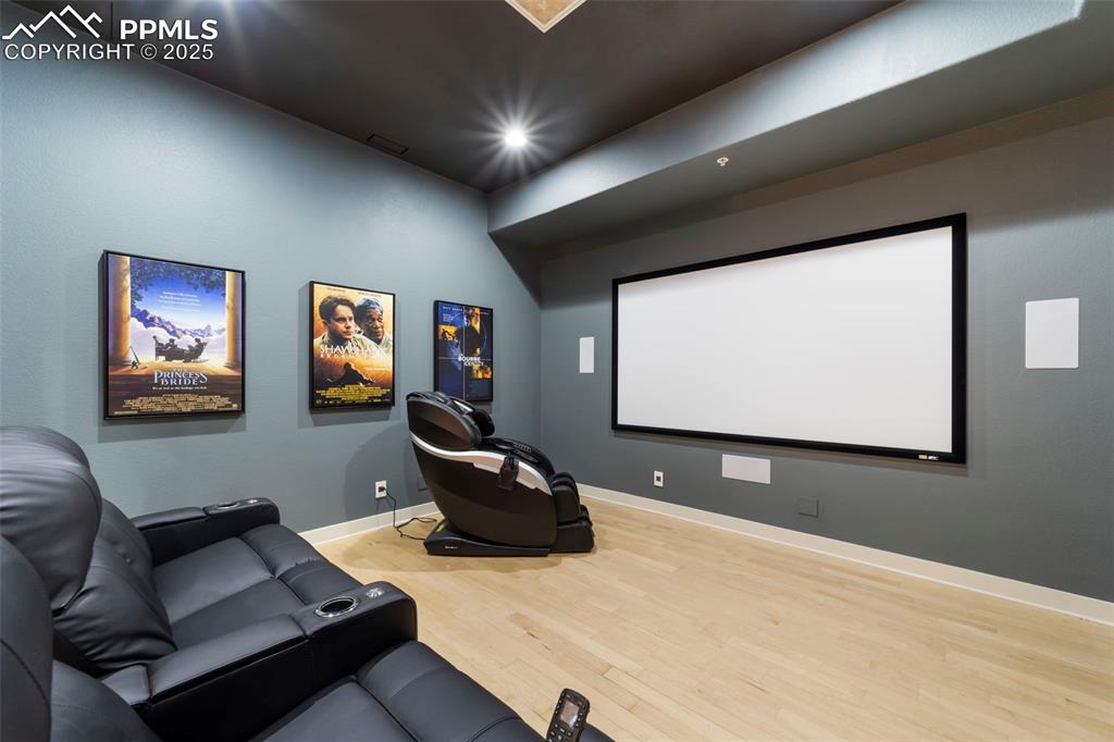 Theater room featuring hardwood floors and recessed lighting. All equipment and seating conveys.