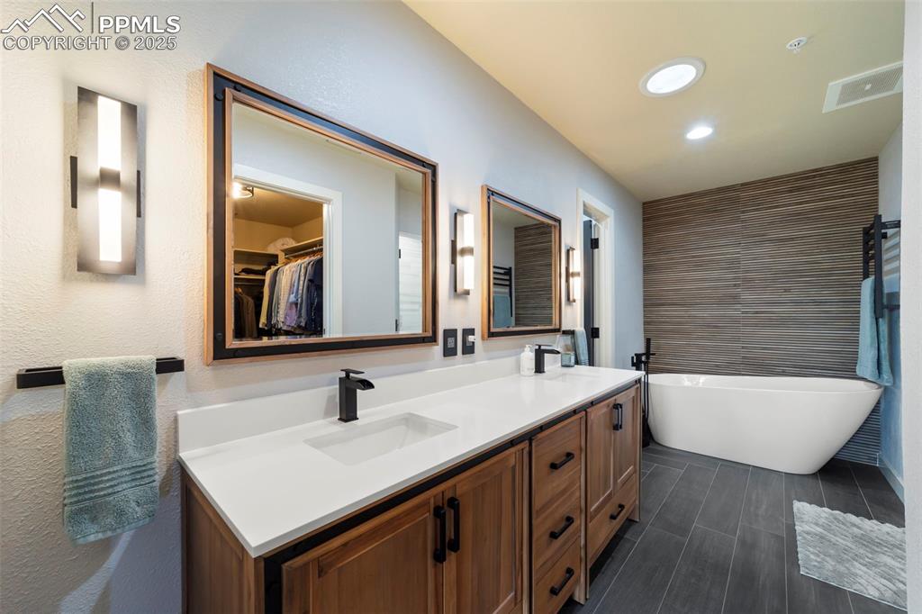 Primary Full bath just renovated and featuring a spacious walk-in closet, a freestanding tub, steam shower/spa shower, double vanity, recessed lighting.
