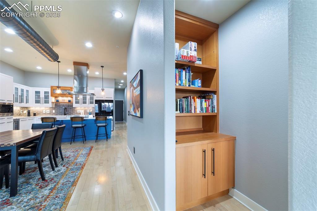 Dining room with hardwood flooring, recessed lighting