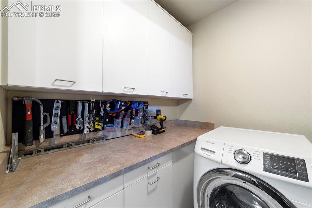 Washroom with washer / dryer and cabinet space and work area