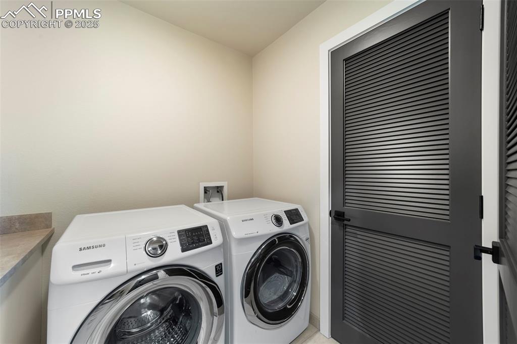 Laundry room featuring washer and clothes dryer