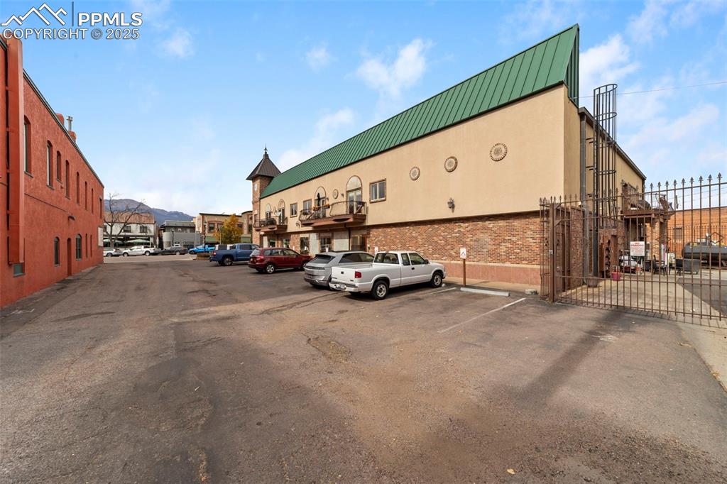 Additional parking lot with a mountain view and a gate