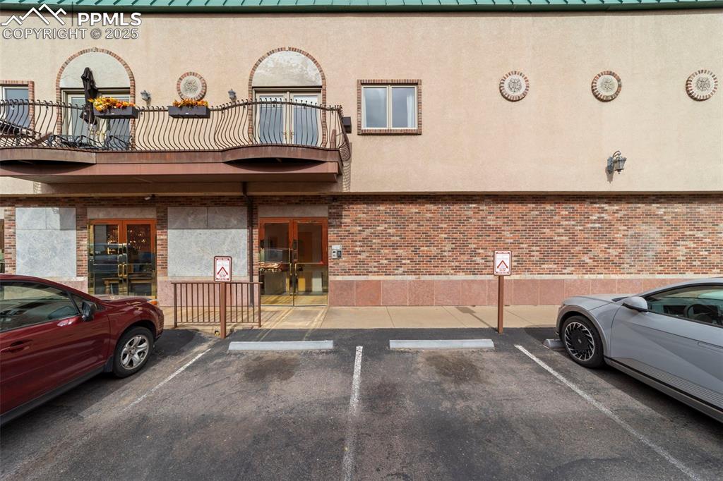 View of building exterior featuring uncovered bonus parking