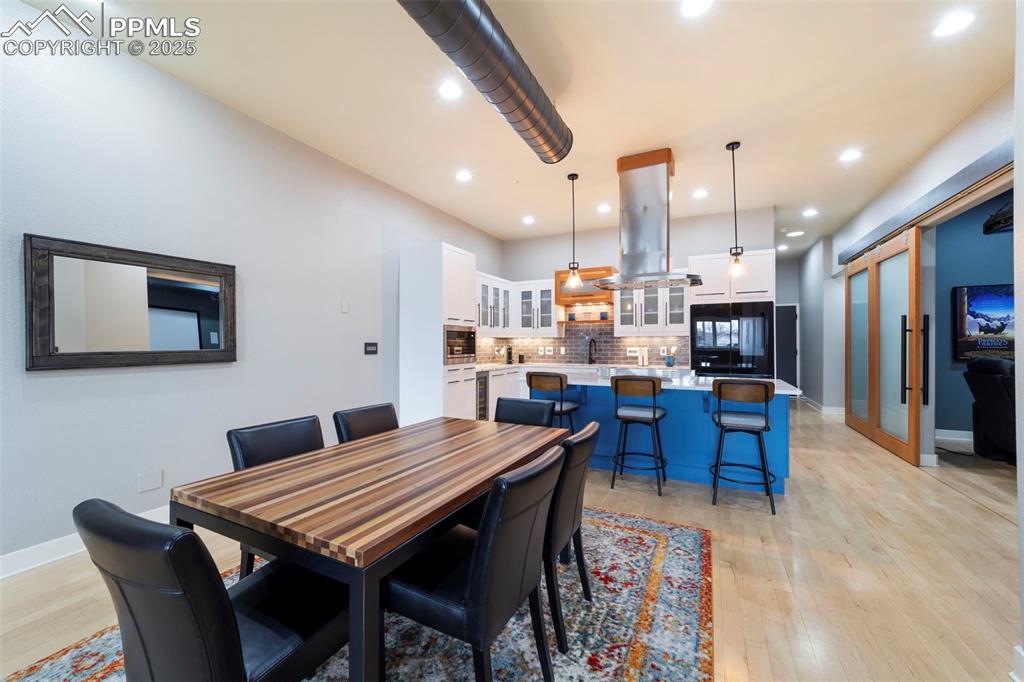 Dining room featuring hardwood flooring and recessed lighting