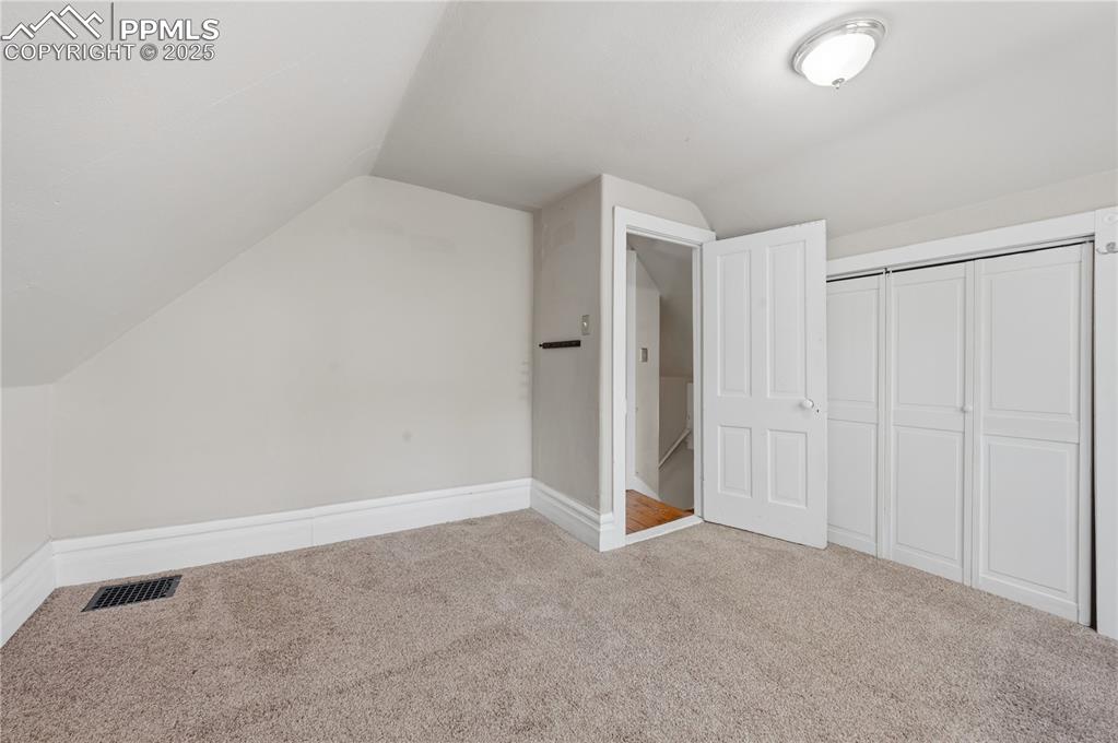 Bonus room with lofted ceiling and carpet floors