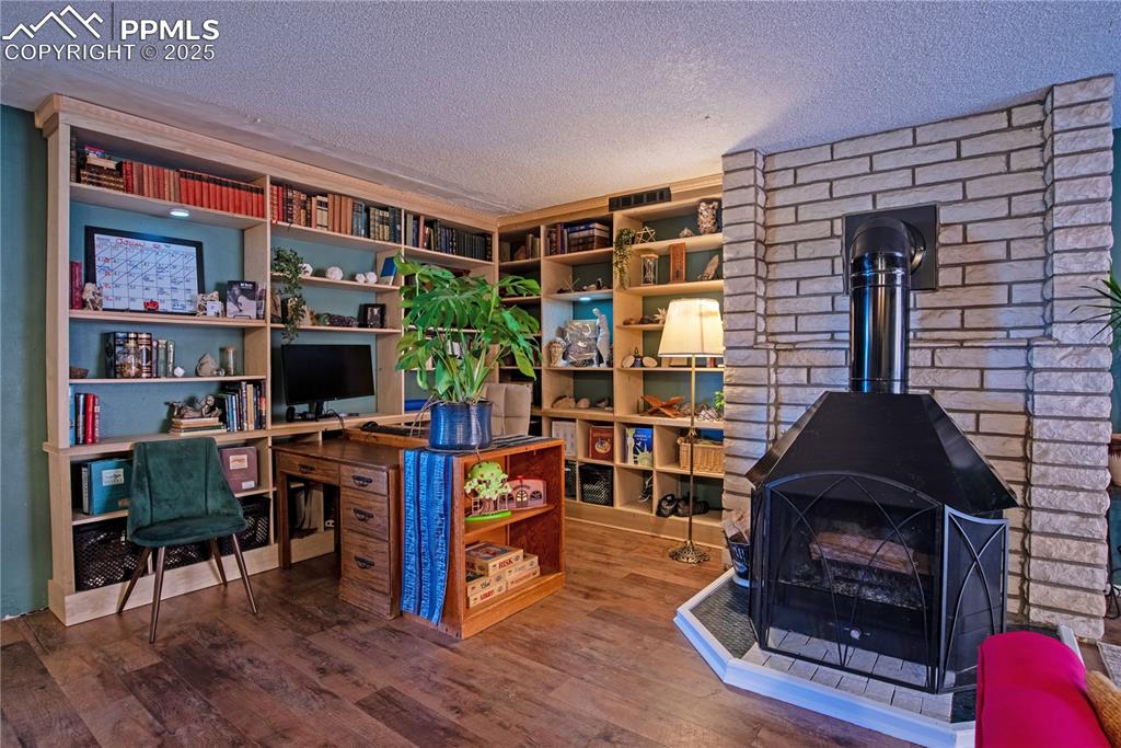Office area, with built-in bookshelves & a wood-burning fireplace 
