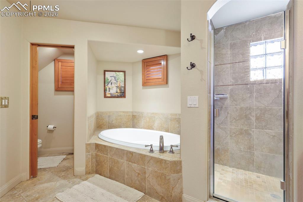 Bathroom with a garden tub and a shower stall