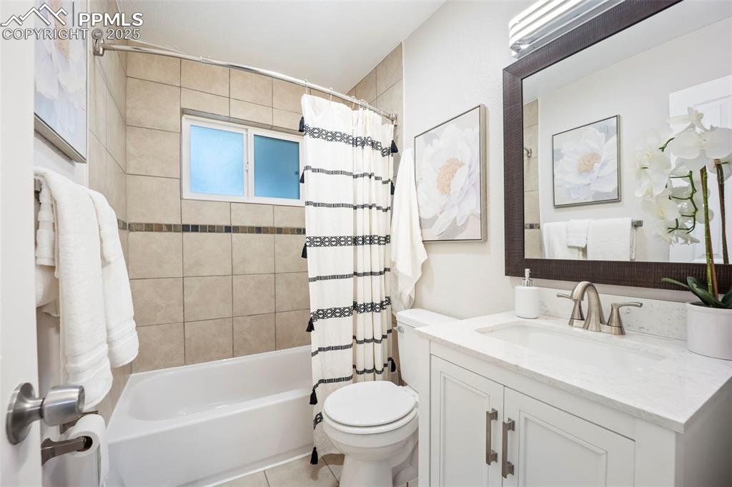 Bathroom (cont) featuring vanity and shower / tub combo with curtain