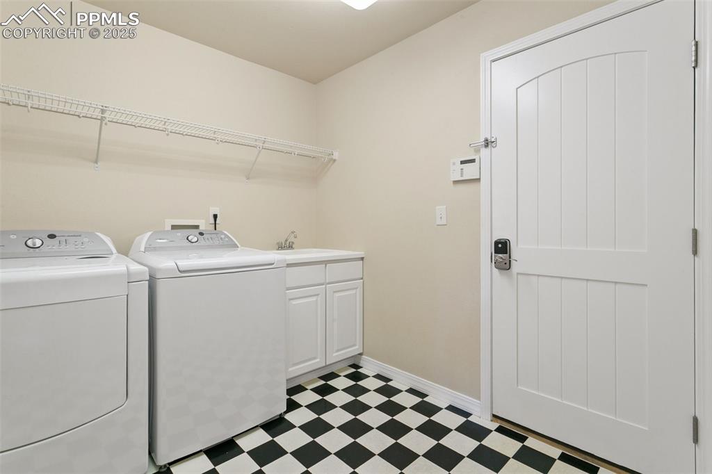 Laundry room featuring independent washer and dryer and light flooring