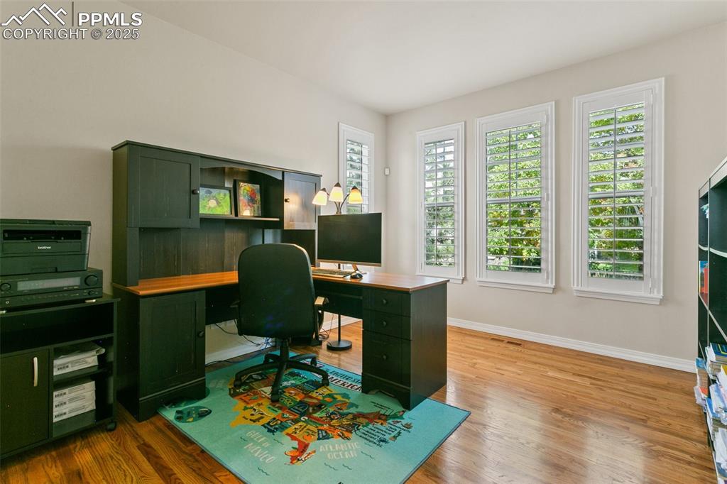 Office space featuring light wood finished floors and baseboards