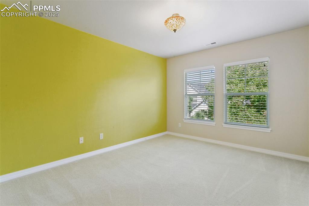 Unfurnished room with carpet floors and baseboards