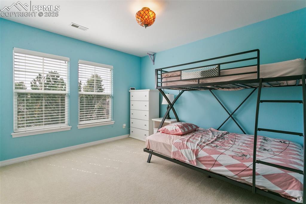 Carpeted bedroom featuring baseboards