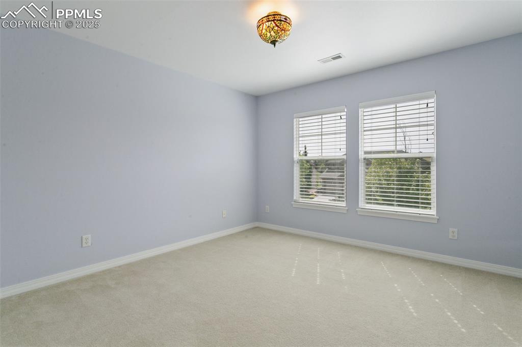 Carpeted spare room with baseboards