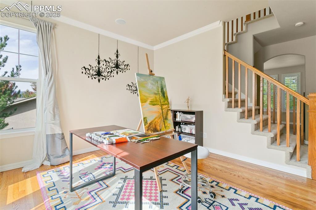 Home office featuring light wood finished floors and ornamental molding