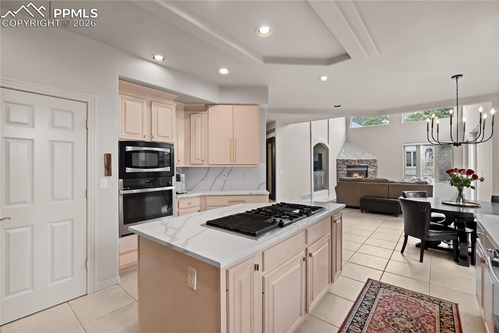 Kitchen with quartz countertop, pantry, gas cooktop and docking drawer (charging station) and breakfast area.