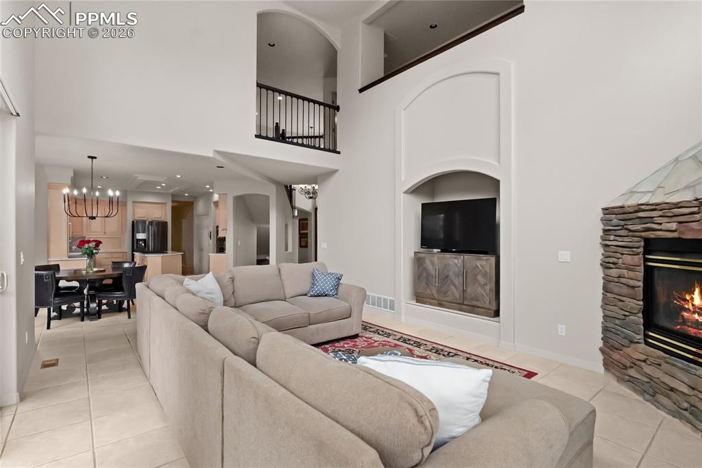 Living room with vaulted ceilings and a fireplace.