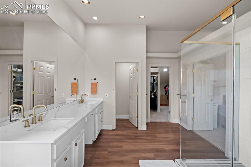 Double vanity, double rain shower heads, frameless glass shower and walk in closet.