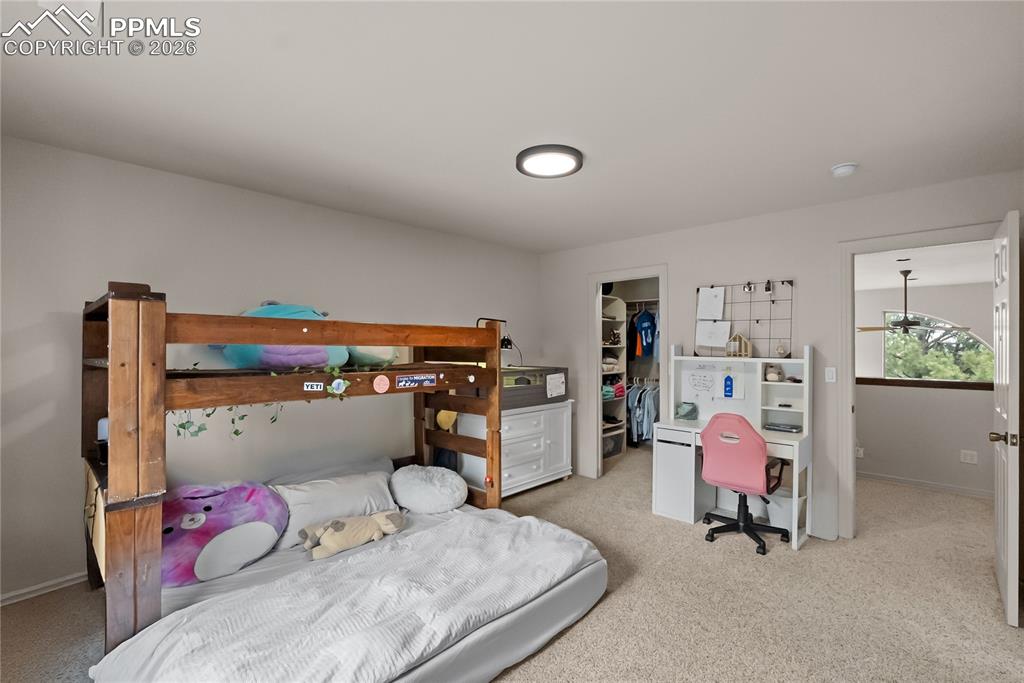 Third bedroom with walk in closet, bookshelf and jack and Jill bathroom.