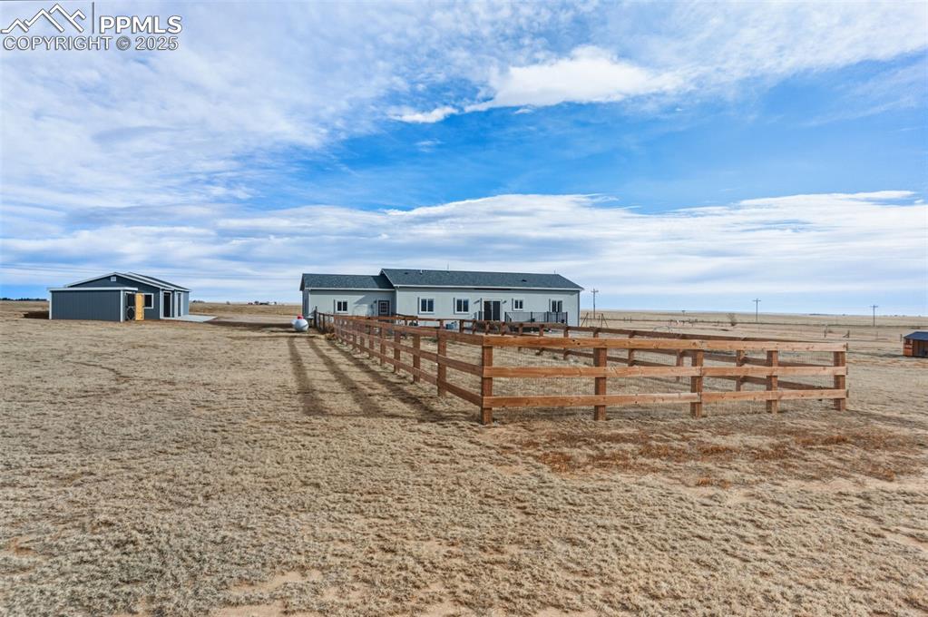 View of yard featuring an outbuilding and a view of rural / pastoral area