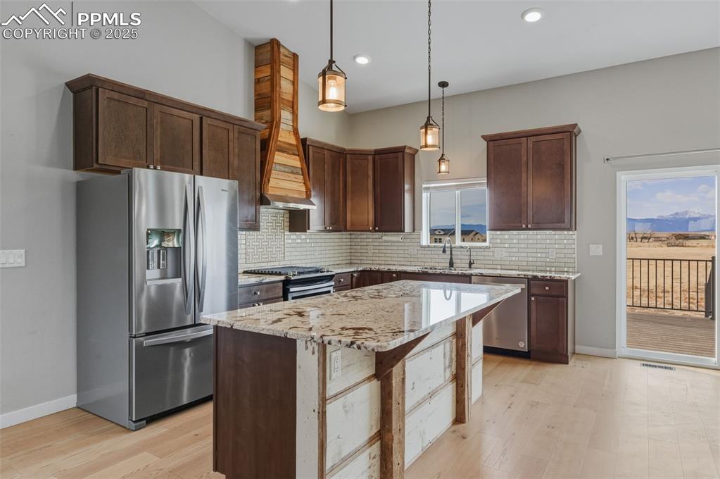 Kitchen stainless steel appliances, slow close cabinets and a kitchen island.