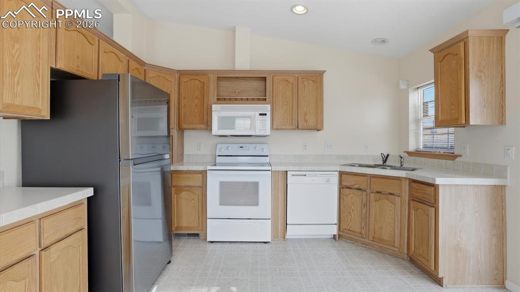 Appliances include a smooth top range oven, microwave, dishwasher, and refrigerator.