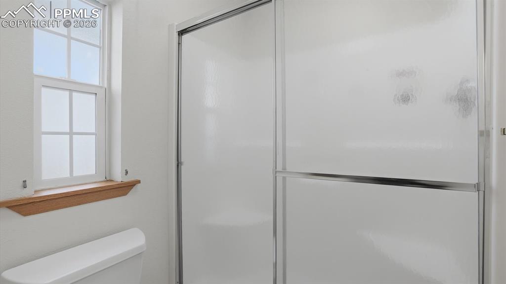 The Primary Bathroom has an enclosed shower with built-in seating.