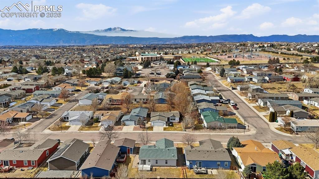 Aerial view of home, neighborhood, and mountains.